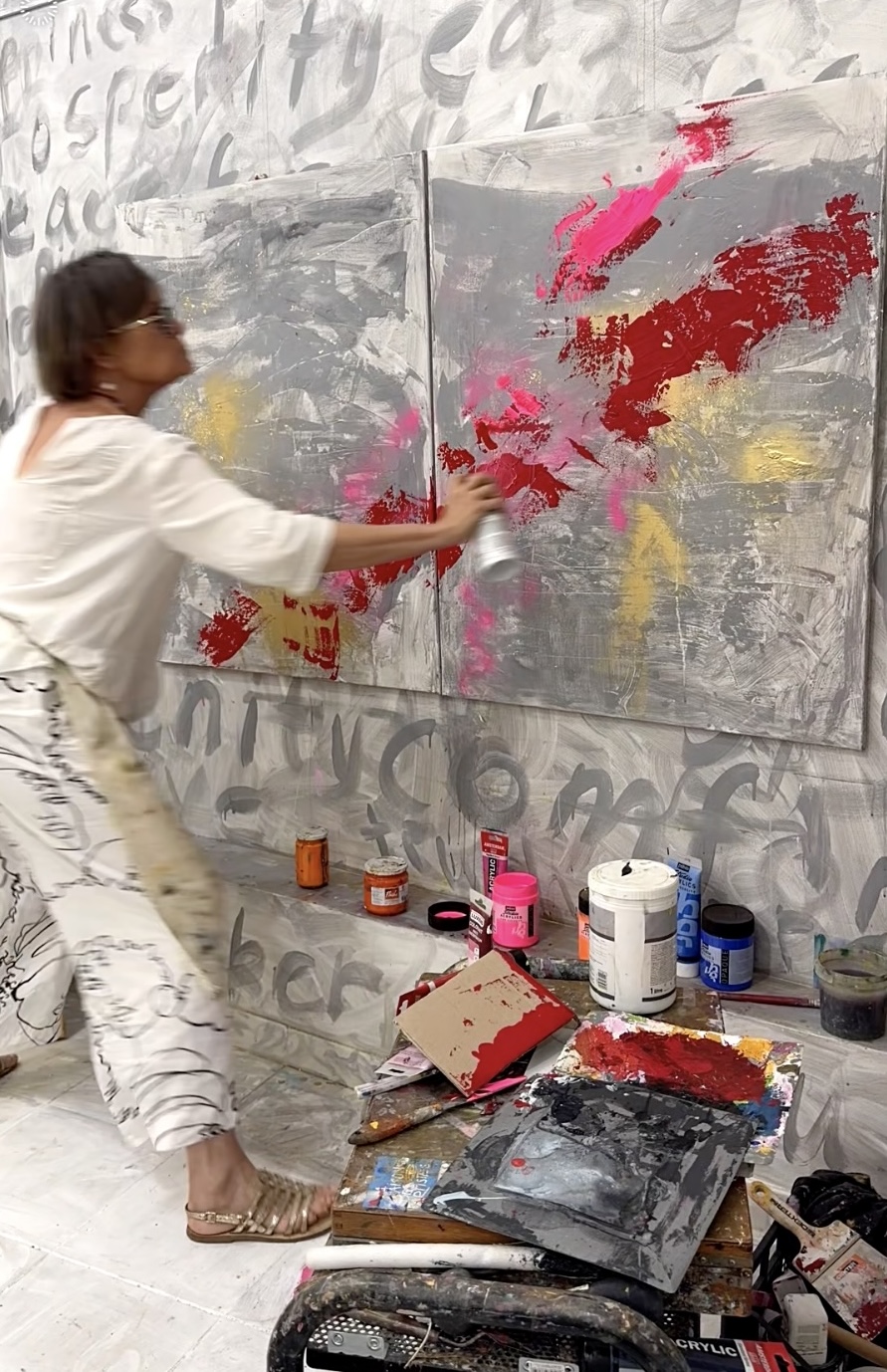 Angie Brooksby using spray paint in her Atelier